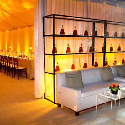 At Hennessy Paradis’ birthday party for Jermaine Dupri, dark shelving prominently displayed cognac bottles.