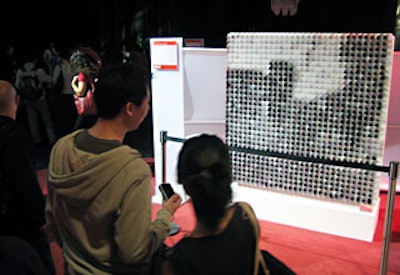 Professor Daniel Rozin of New York University’s Tisch School of the Arts’ Interactive Telecommunications Program created the Circles Mirror, which simulates a pixilated reflection of people standing in front of it. The work is made up of 900 motorized circles—each shaded with gradations of white to black.