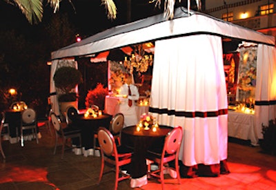 A black and white canopy strung with a crystal chandelier sat in the center of the Chateau Marmont’s courtyard garden.