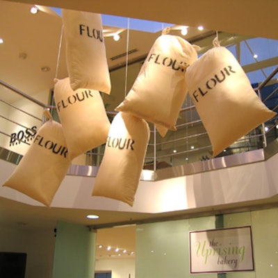 Bags stenciled with the word 'FLOUR' hung from the two-story ceiling.