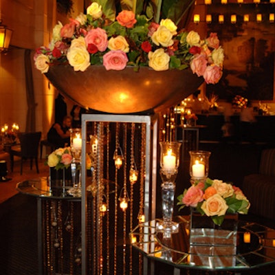 Forget Me Not supplied massive arrangements of roses that spilled out of large, uplit copper bowls.