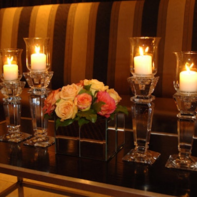 Glass candlestick holders flanked miniature versions of the large floral arrangements.