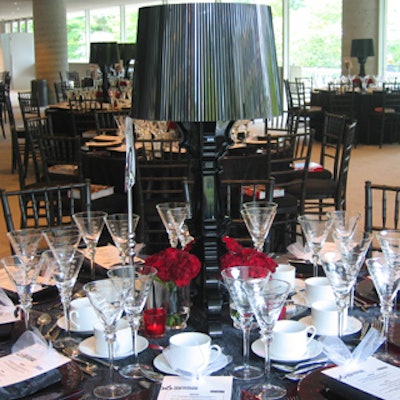 Black satin table linens and black burgee lamps helped conjure a sense of gloom in the dining area to reflect the film's emotionally draining portrayal of married life.