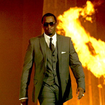 Rapper Diddy emerged from fiery hoops on the runway for Macy's AIDS fund-raiser Passport at Santa Monica Airport's Barker Hangar.