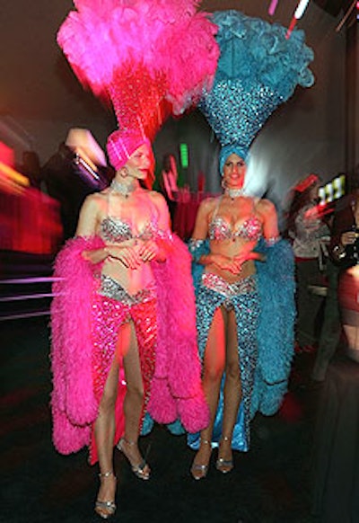 Models, dressed like showgirls, meandered about the preshow party space in brightly colored, barely-there costumes.