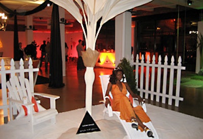 A beach scene with sand and a white picket fence represented White Tea, and the model's orange dress was a tribute to the tea's mango infusions.