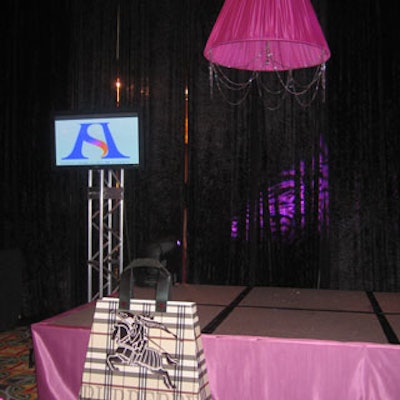 The stage was further accented with chandelier-style shades and oversize designer handbags.