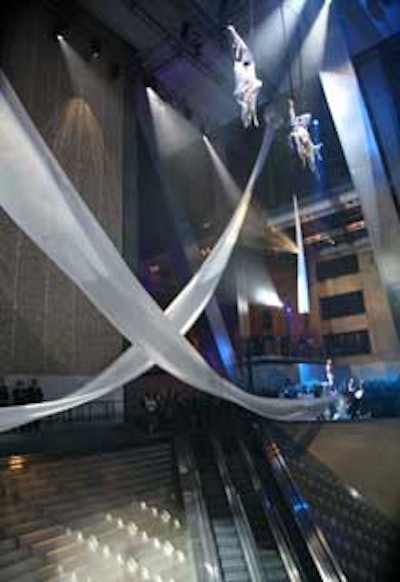 The nontraditional ribbon cutting consisted of a performance by six aerialists flipping, bouncing, and twisting some 100 feet above the crowd.