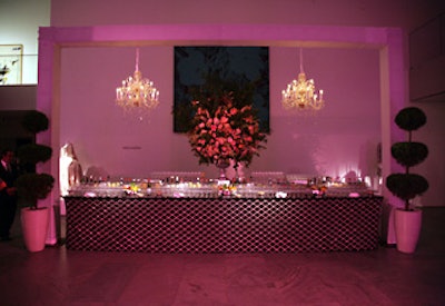 Topiaries, crystal chandeliers, and a nine-foot-tall bouquet of flowers by Ron Wendt Designs accented the main bar.