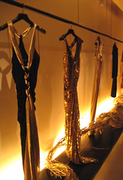 JKLD lit clothing from the Donna Karan Gold capsule collection from below with golden gels, and the boutique’s in-house visual team framed it with swirling gold branches.