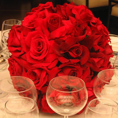 Red-rose centerpieces from floral designer Chad Finucan topped the dinner tables.