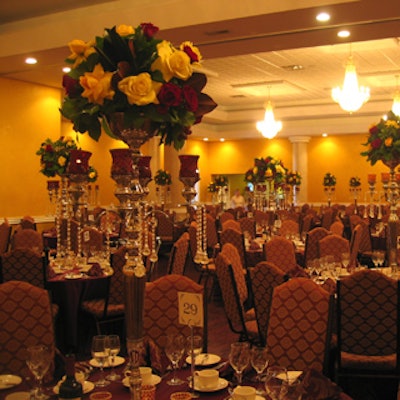 Candelabras filled with pastoral flowers and foliage from Designing Trendz Candelabras and elegant florals from Designing Trendz supported the King Arthur's Court theme in the main dining hall.