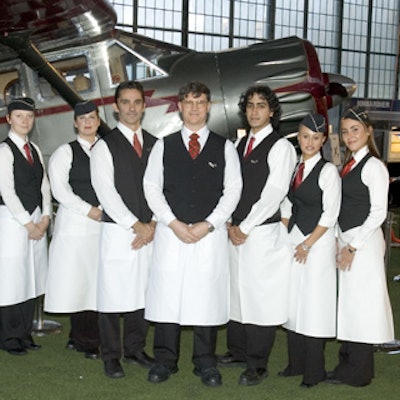 Female caterwaiters wore 50's-style stewardess hats along with standard serving uniforms for men and women during Toronto Aerospace Museum's fund-raising gala at Downsview Hangar to celebrate the official unveiling of its replica Avro Arrow fighter jet.