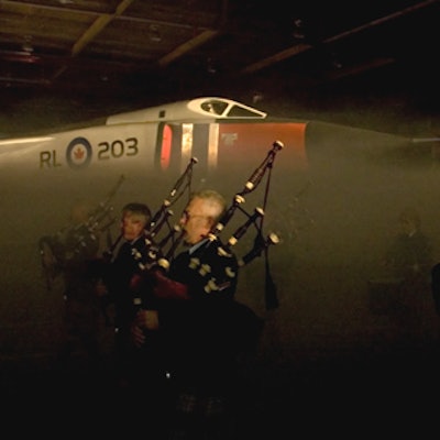 The 400 Squadron Pipe Band played as it led guests to the showroom, where fog shrouded the 80-foot aircraft.