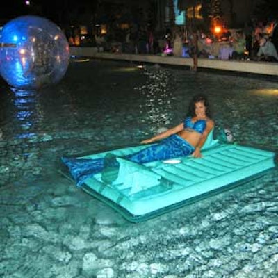 A sparkly mermaid lounged on a floating raft provided by Grand Events of Florida.