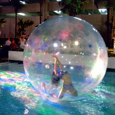 Another performer from Event Show Productions stretched and danced within a seven-foot sphere that floated on the water.