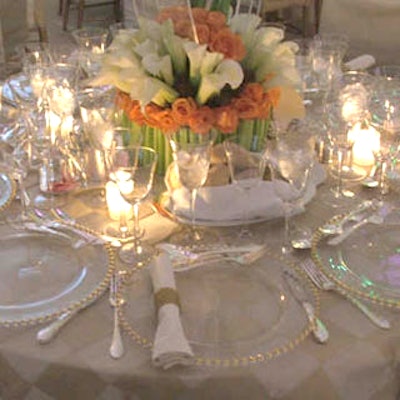 Barton G. dressed the tables with luxurious crystal ware, formal square-patterned linens, and beautiful centerpieces that mixed calla lilies, orchids, and roses.