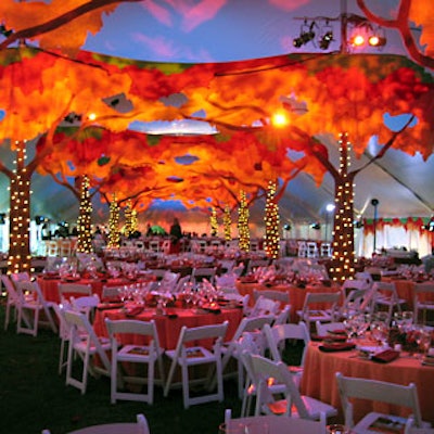 To decorate the dinner tent’s structural poles, the event’s designers created theatrical trees with felt tops and foam branches.