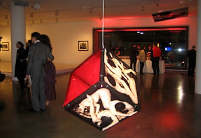A suspended cube made of semitransparent images from the book lit up the center of Milk Gallery.