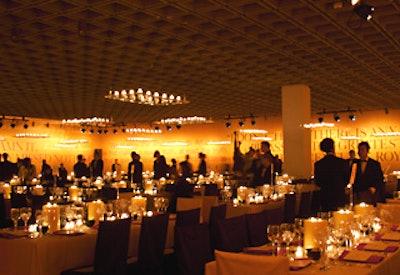 Event producer Antony Todd created a warm ambience for the gala's dinner by placing large candles on each table. Polished Lucite chandeliers hung from the ceiling, each dotted with dozens of tea light candles.