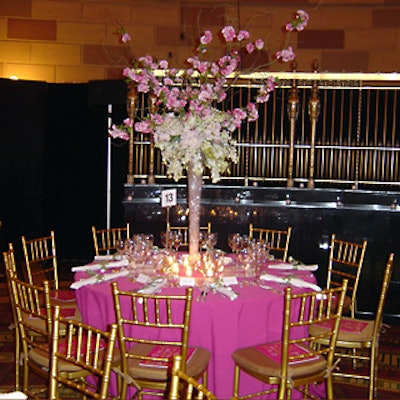 Roses, peonies, and wild flowers topped pink tablecloths.