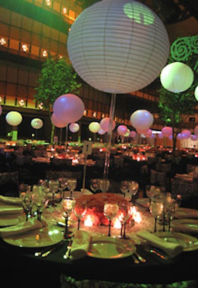 Paper lanterns on clear acrylic rods and short arrangements of pink carnations comprised each table’s centerpiece.