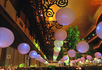 A row of paper lanterns hanging from curvy sconces added a whimsical element to the events modern look.