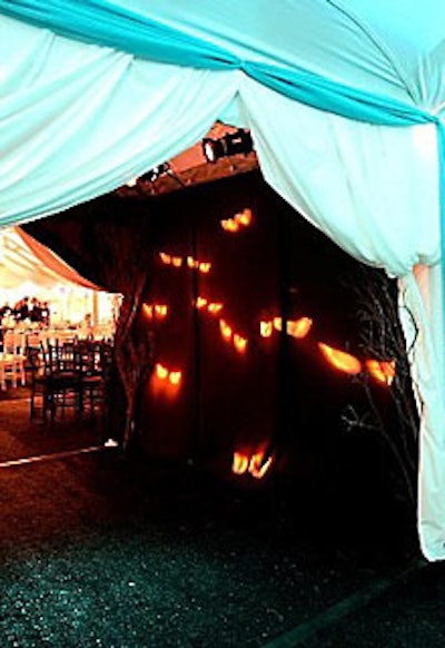 Guests walked through a hallway with glowing orange eye projections to enter the dinner tent.