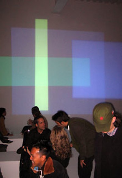 A block pattern of colors was projected onto the wall adjacent to a seating area and the Lexus display car.