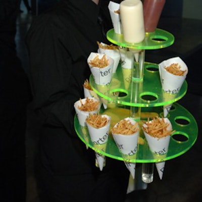 Eatertainment displayed paper cones filled with shoestring French fries in multi-tiered, green plastic stands.