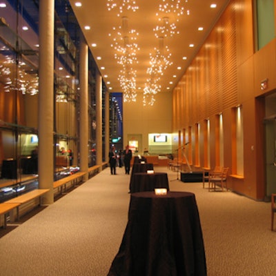 The Henry N.R. Jackman lounge featured tables covered by chocolate brown window-pane linen and topped by lit votives, all from Chair-man Mills.