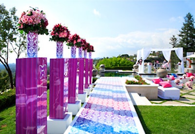 Caravents decked out a tiered backyard overlooking the city with girly florals and stripes in pink, purple, and teal covering vases, pedestals, and the front of the sushi bar.