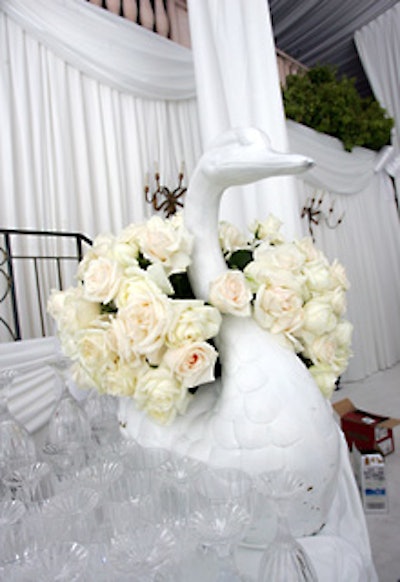 White roses overflowed from a swan-decor piece on the main bar.