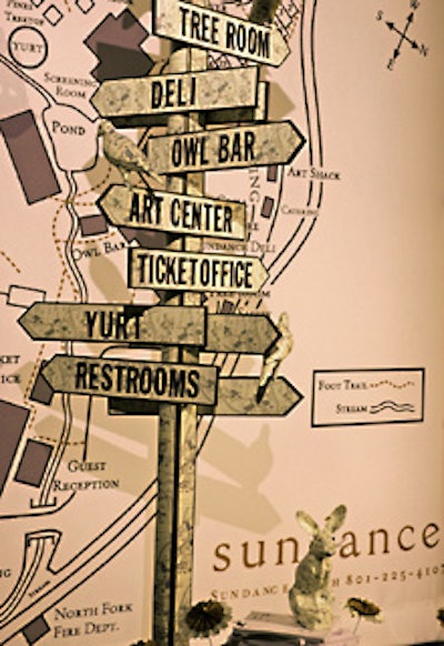 Covered with maps, a signpost with directions to various sections of the Sundance property stood at the entry to the event. (Maps also covered little birds perched on the sign.)