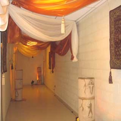 Guests were ushered through a themed hallway Daniel Events decorated with ornate rugs, pedestals, and sheer draping.