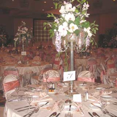 One of the centerpieces featured a tall, brushed metal vase-and-candleholder combo with magnolias and other floral accents.