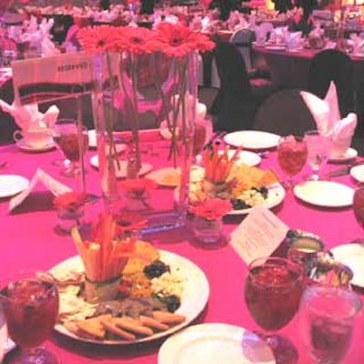 Another centerpiece consisted of a tall rectangular vase with pink Gerber daisies.