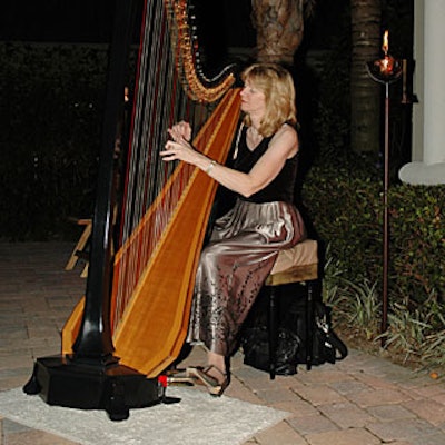 The 125 attendees were given red carpet treatment, as they entered the honorary consul's home to the sounds of this female Harpist.