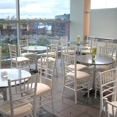 Chair-man Mills furnished the caf? with diamond-plated caf? tables and white chiavari chairs.