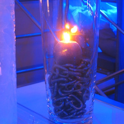 Chains and candles in clear glass vases decorated buffet stations.