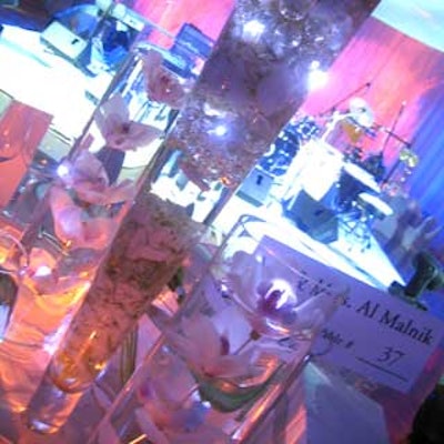 The other centerpieces were made using multiple vases with floating flowers, LED lighting, and shimmering jeweled rocks.