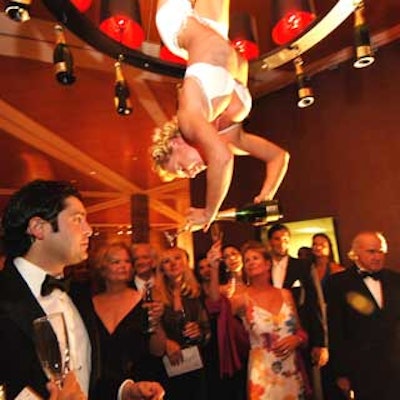 Ninine Linning, the Champagne Lady from Holland, hung upside down and poured glasses of bubbly before guests entered the ballroom.