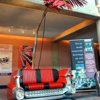 Caddy couches and multicolored palm trees gave the room a retro look.