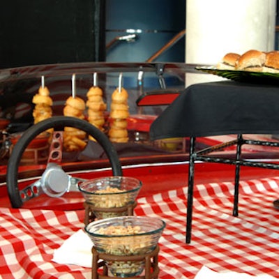 The center's catering team served golden onion rings and mini burgers on a red Corvette.
