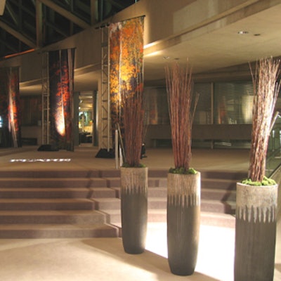 Barren branches and banners with painted-on leaves protruded from the tops of tall urns in the foyer.