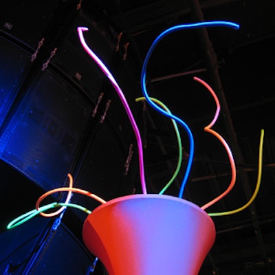 Colourful twisted wires protruded from large, hourglass-shaped spandex vase structures.