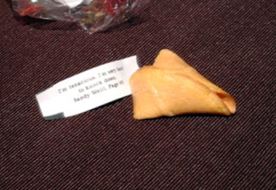 Guests cracked open fortune cookies from Won Ton Food that contained quotes from famous dealmakers such as Sandy Weill.