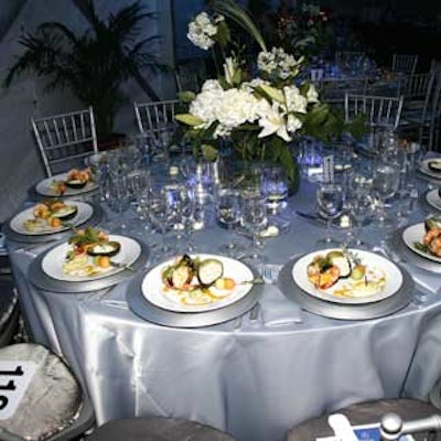 Tables were decked in silver or black tablecloths and topped with centerpieces by A Tablescape Rental Corporation.