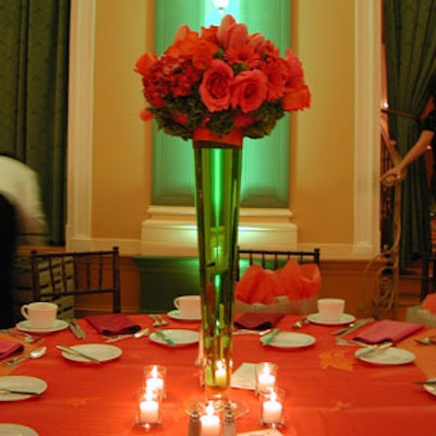 One of the centerpieces consisted of tall arrangements of orange roses, hydrangeas, tulips, and daisies.