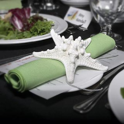 Starfish clips adorned green napkins at some of the dining room place settings.